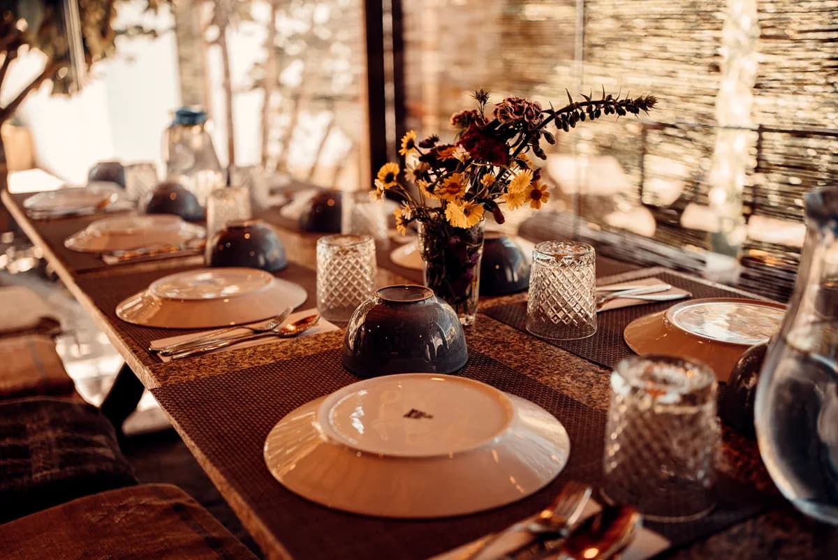 Long communal dining table set for dinner under string lights at Quinta do Rabaçal, Portugal