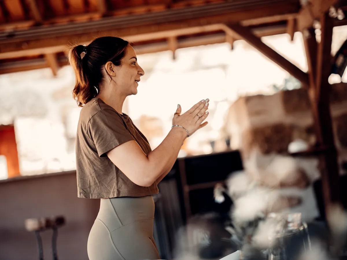 Guest journaling in a butterfly chair on the terrace