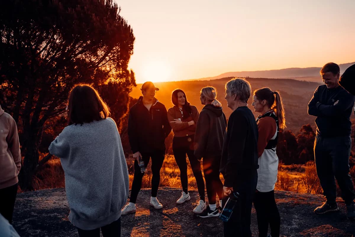 Retreat guests gathered on a hilltop at sunrise overlooking the Portuguese valley at Quinta do Rabaçal