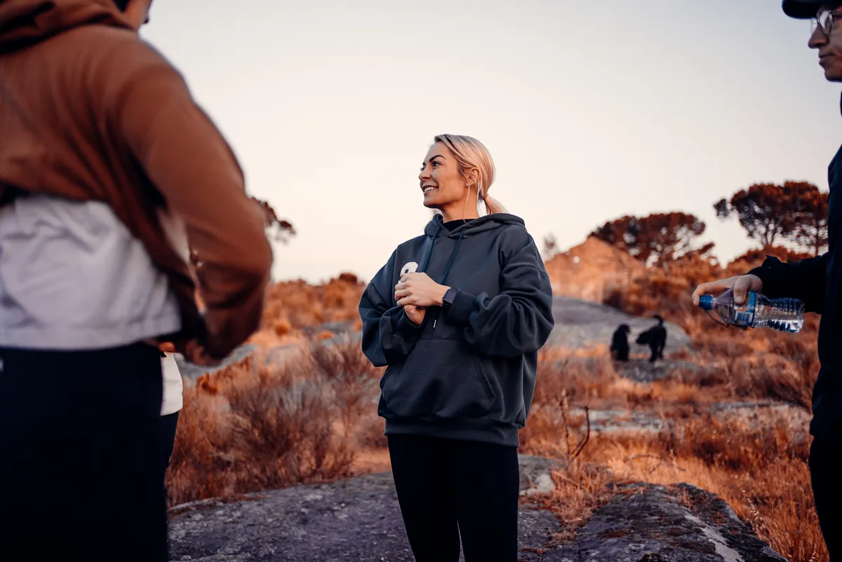 Elysium Retreats guest smiling candidly on a Portuguese hilltop at golden hour