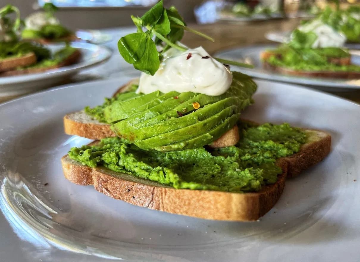 Smashed avocado on sourdough toast with pea shoots