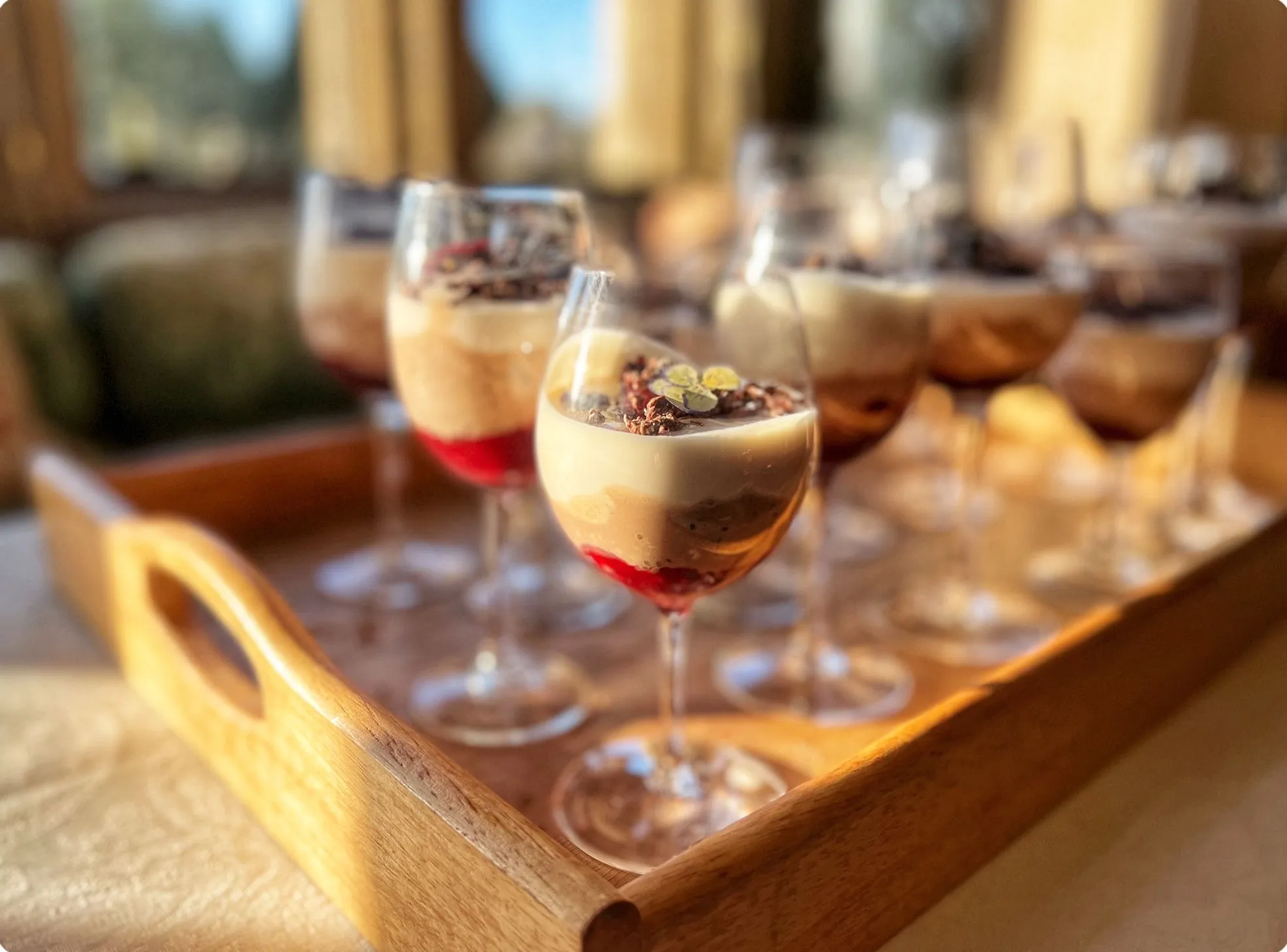 Chocolate mousse desserts served in wine glasses with berry compote