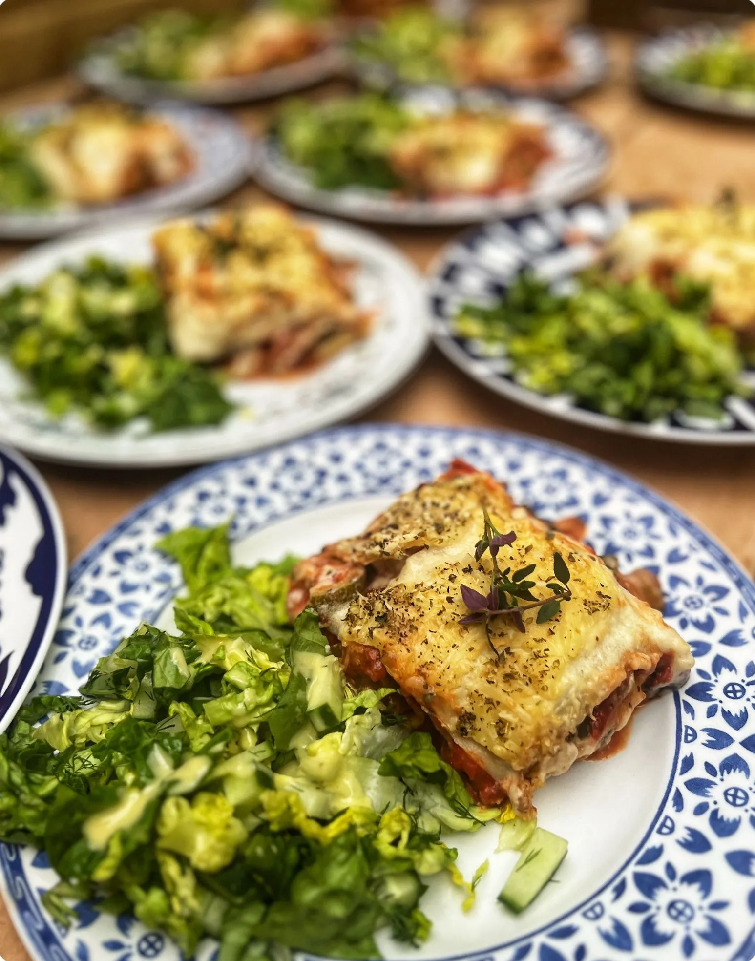 Freshly baked lasagne served with crisp green salad