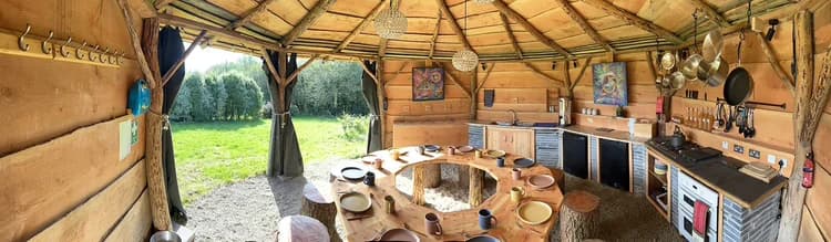 The open-air kitchen with round communal dining table, where meals are shared together